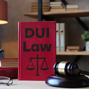 Red law book titled "DUI Law" with a judge's gavel on a table - The Emory Law Firm