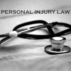 Stethoscope on table with the words 'Personal Injury Law' in bold above it